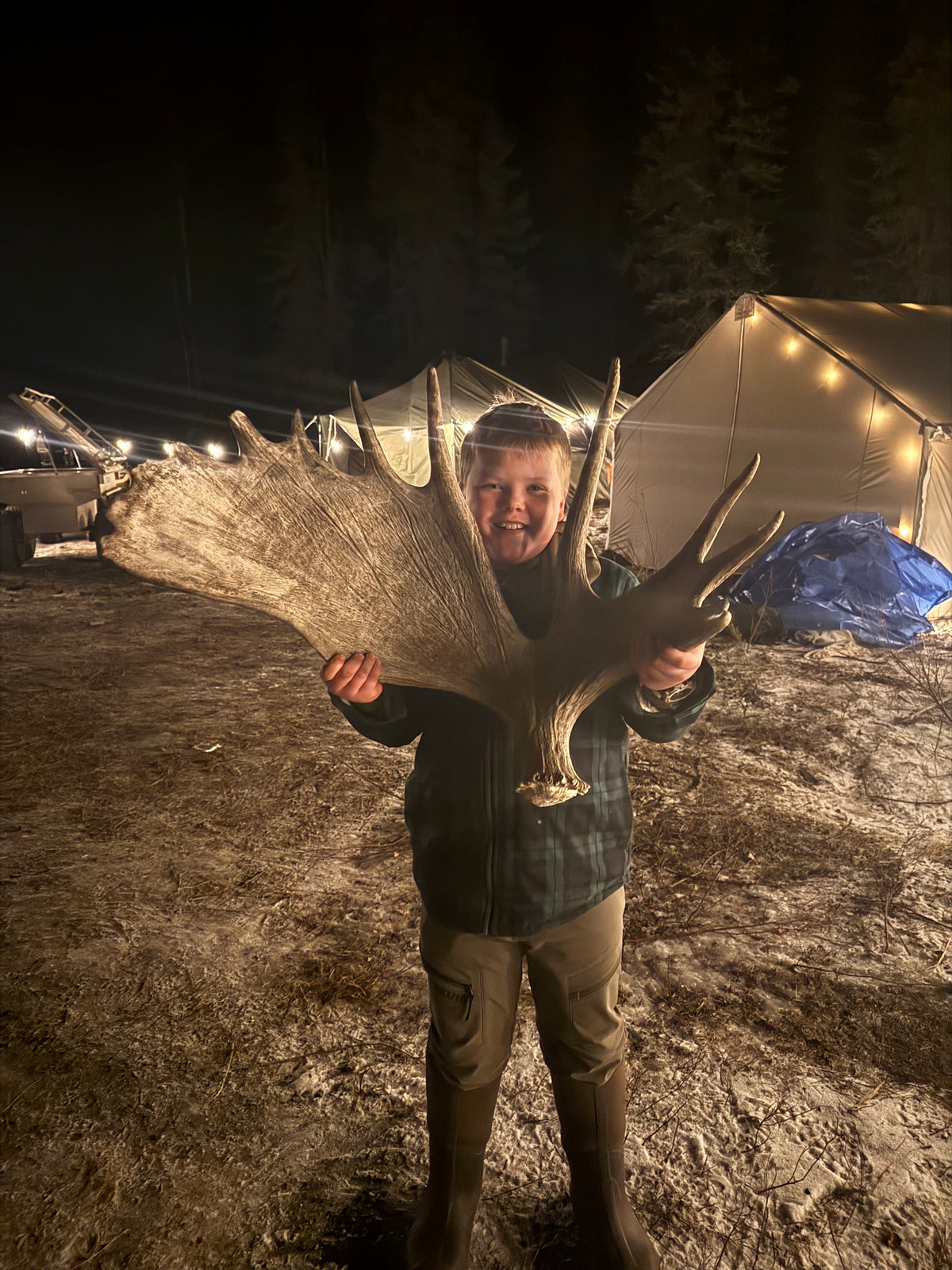 A moose shed found near camp, held up in front of the wall tents